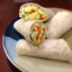 whole wheat burritos filled with egg and red and green pepper cut on a plate