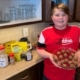 boy in kitchen holding plate of energy balls
