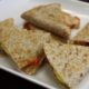 whole wheat breakfast quesadilla toasted and cut in triangle and placed on a while plate